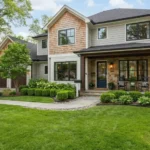 Well maintained suburban home exterior with tidy landscaping and a welcoming front porch